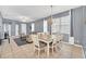 Bright dining room with gray walls and a farmhouse style table with six chairs at 306 Kettering Rd, Davenport, FL 33897