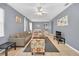 Bright living room featuring gray walls, tiled floors, and a cozy seating area at 306 Kettering Rd, Davenport, FL 33897