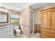 Bathroom with a walk-in shower, white vanity, and wooden cabinet at 322 Apopka St, Winter Garden, FL 34787