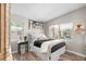 Bright bedroom with a white metal bed frame and hardwood floors at 322 Apopka St, Winter Garden, FL 34787