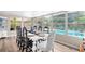 Sun-drenched dining room with white table and pool view at 322 Apopka St, Winter Garden, FL 34787