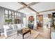 Spacious living room features exposed wooden beams, a white couch, and a large TV at 322 Apopka St, Winter Garden, FL 34787