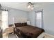 Bedroom with a brown comforter, ceiling fan, and two windows at 332 Apopka Hills Cir, Apopka, FL 32703