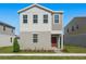 Two-story house with gray siding, red door, and small front yard at 360 Belmond Dr, Debary, FL 32713