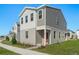 Modern two-story house with gray siding and a red door at 360 Belmond Dr, Debary, FL 32713