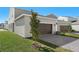 Brown garage door with brick paver driveway and landscaping at 360 Belmond Dr, Debary, FL 32713