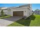 Brown garage door with brick pavers and landscaping at 360 Belmond Dr, Debary, FL 32713