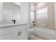 Modern bathroom with white vanity, bathtub, and marble-style shower walls at 4670 Sw 142Nd Place Rd, Ocala, FL 34473