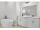 Elegant bathroom with double vanity, soaking tub, and modern fixtures at 4670 Sw 142Nd Place Rd, Ocala, FL 34473