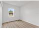 Bright bedroom with large window and wood-look flooring at 4670 Sw 142Nd Place Rd, Ocala, FL 34473