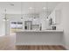 Modern kitchen island with white cabinets and quartz countertops at 4670 Sw 142Nd Place Rd, Ocala, FL 34473