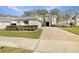 Two-story house with brick paver driveway and manicured landscaping at 4957 Rock Rose Loop, Sanford, FL 32771