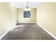 Empty dining room with chandelier and a window at 511 Cloudcroft Dr, Deltona, FL 32738