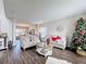 Living room with hardwood floors, comfortable seating, and a view into the dining area at 5417 Calla Lily Ct, Kissimmee, FL 34758