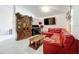 Living room with red sectional sofa, coffee table, and wood cabinet at 5633 Piney Ridge Dr, Orlando, FL 32808