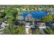 Aerial view showing a home on a lake with surrounding houses and trees at 58 Bonita Rd, Debary, FL 32713