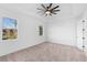 Bright bedroom with ceiling fan, neutral carpeting, and large windows at 58 Bonita Rd, Debary, FL 32713