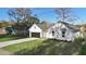 White modern farmhouse with a dark garage door and nicely landscaped yard at 58 Bonita Rd, Debary, FL 32713