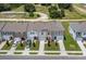 Aerial view of townhouses with driveways and landscaping at 5912 Piney Shrub Pl, Saint Cloud, FL 34771