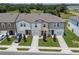 Aerial view of three townhouses with driveways and landscaping at 5912 Piney Shrub Pl, Saint Cloud, FL 34771