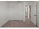 Spacious bedroom with carpeting and access to a hallway at 5912 Piney Shrub Pl, Saint Cloud, FL 34771