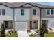 Two-story townhome with neutral siding and a two-car garage at 5912 Piney Shrub Pl, Saint Cloud, FL 34771