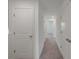 Hallway with carpet and doors to bedrooms at 5912 Piney Shrub Pl, Saint Cloud, FL 34771