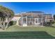 View of home's back exterior and screened porch at 5942 Nw 26Th Ln, Ocala, FL 34482