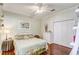 Cozy bedroom with a leafy green comforter and hardwood floors at 5942 Nw 26Th Ln, Ocala, FL 34482