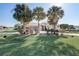 Beautiful home with palm trees and manicured lawn at 5942 Nw 26Th Ln, Ocala, FL 34482