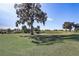 Scenic view of a lush green golf course with mature trees at 5942 Nw 26Th Ln, Ocala, FL 34482