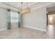 Bright dining room with wood-framed chandelier and light gray walls at 597 Lost Shaker Way, Daytona Beach, FL 32124