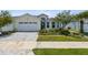 House exterior featuring a two-car garage and well-manicured lawn at 597 Lost Shaker Way, Daytona Beach, FL 32124