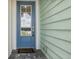 Blue front door with a glass panel and welcome mat at 597 Lost Shaker Way, Daytona Beach, FL 32124