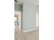 Light gray hallway with white doors and light wood-look tile floor at 597 Lost Shaker Way, Daytona Beach, FL 32124