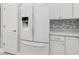 White Samsung French door refrigerator in a modern kitchen setting at 597 Lost Shaker Way, Daytona Beach, FL 32124