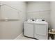 Laundry room with washer, dryer, and shelving at 597 Lost Shaker Way, Daytona Beach, FL 32124