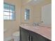 Bathroom with granite countertops, double sinks, and a window at 605 Brightview Dr, Lake Mary, FL 32746