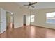 Large bedroom with wood flooring, multiple windows, and access to other rooms at 605 Brightview Dr, Lake Mary, FL 32746