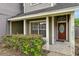 Front entrance with a brown door and lush green bushes at 605 Brightview Dr, Lake Mary, FL 32746