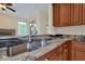 Kitchen boasts granite countertops and a double sink at 605 Brightview Dr, Lake Mary, FL 32746