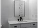 Modern bathroom with white vanity, black fixtures, and a large mirror at 6921 Arnoldson St, Orlando, FL 32827