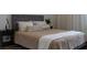 Cozy bedroom featuring a tufted headboard, neutral bedding, and stylish nightstands for added convenience at 6921 Arnoldson St, Orlando, FL 32827