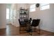 This dining area features a modern table and chairs set with an eye-catching shelf and wood flooring at 6921 Arnoldson St, Orlando, FL 32827