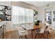 Bright dining room with wood table, white chairs, and view to backyard at 6921 Arnoldson St, Orlando, FL 32827