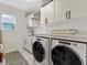 Modern laundry room with washer, dryer, and ample storage at 6921 Arnoldson St, Orlando, FL 32827