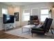 This living room features bright, natural light, a TV, and a comfortable futon perfect for relaxing at 6921 Arnoldson St, Orlando, FL 32827