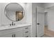 Modern bathroom with white vanity and large round mirror at 7 1 St Ct, Windermere, FL 34786