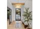 Bright entryway with a statement light fixture and stylish bench at 7 1 St Ct, Windermere, FL 34786