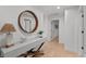 Bright hallway with light gray console table and large mirror at 7 1 St Ct, Windermere, FL 34786